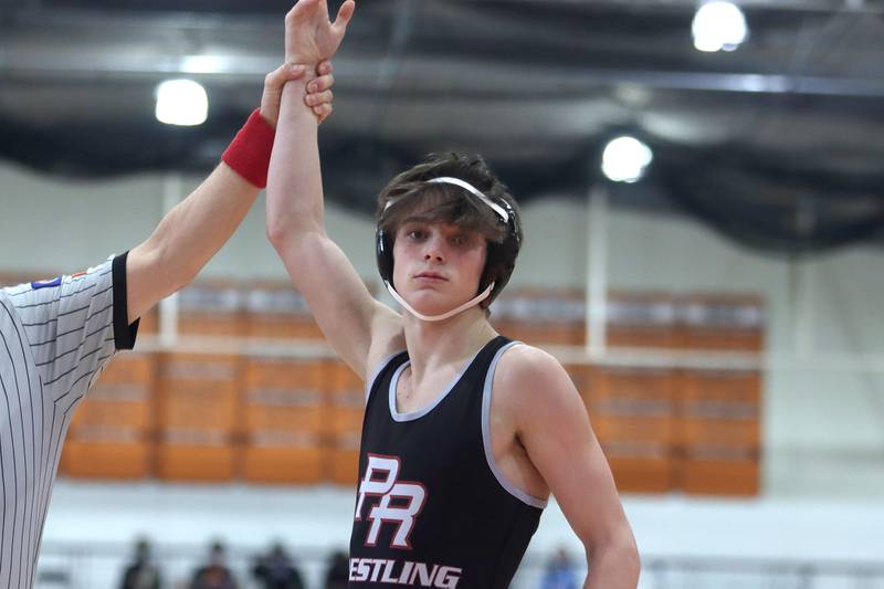 Prairie Ridge’s Tyler Evans won the title bout at 120 pounds over Woodstock’s Caleb Sciame during IHSA Class 2A regional wrestling at Crystal Lake Central Saturday.