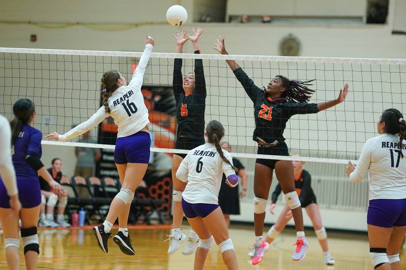 Plano's Chloe Rowe (16) goes up for a kill against Sandwich's Londyn Scott (6) and Alayla Harris (21) during a volleyball match at Sandwich High School on Tuesday, Sep 10, 2024.