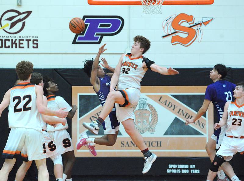 Plano's Amari Bryant gets fouled hard by Sandwich defender Quinn Rome (32) during a varsity basketball game at Sandwich High School on Tuesday, Feb. 13, 2024.