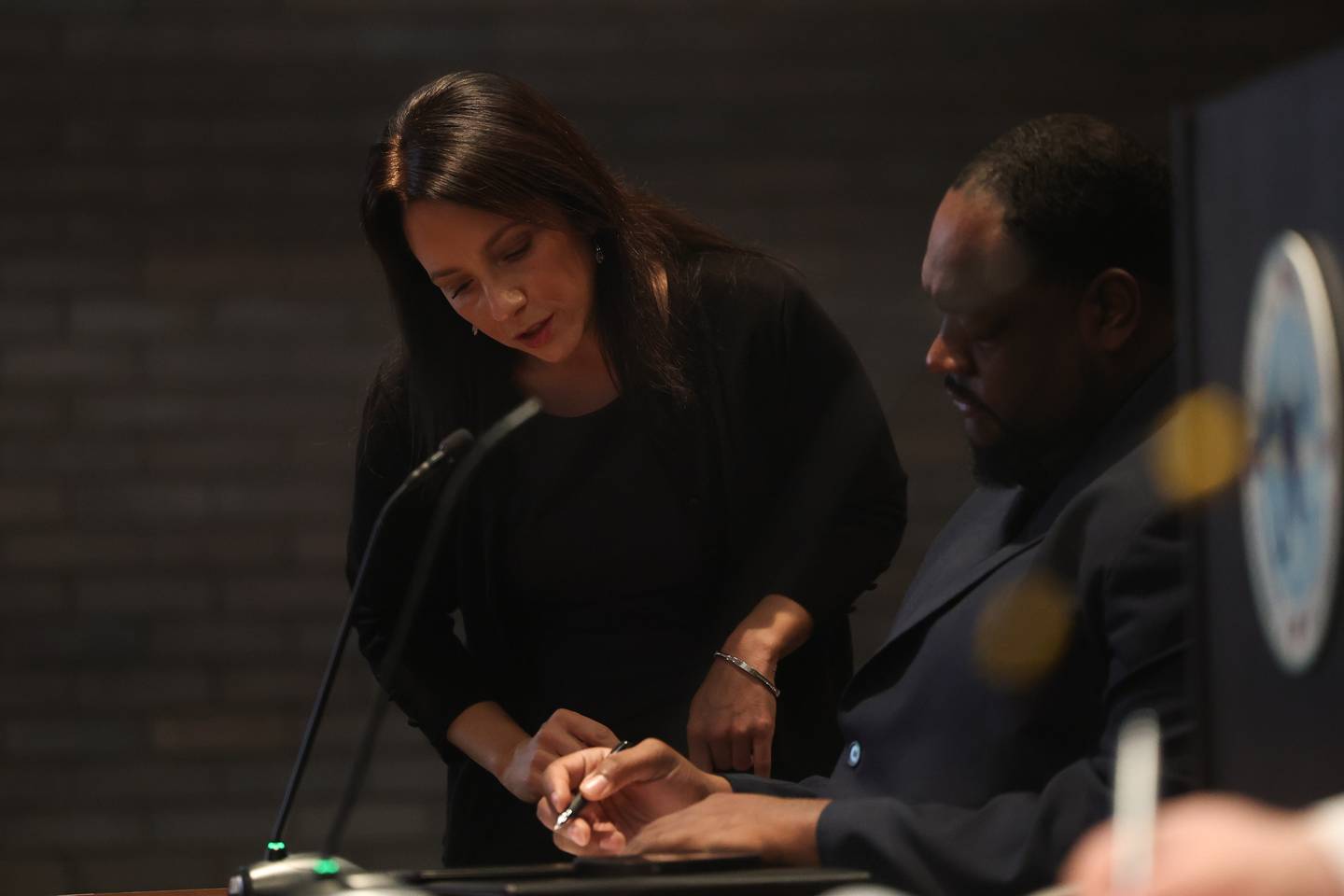 Corperation Counsel Sabrina Spano goes over paperwork with City Council candidate Christopher Parker at a hearing on the validity of his nominating petitions at the Joliet City Electoral Board meeting on January 4th.