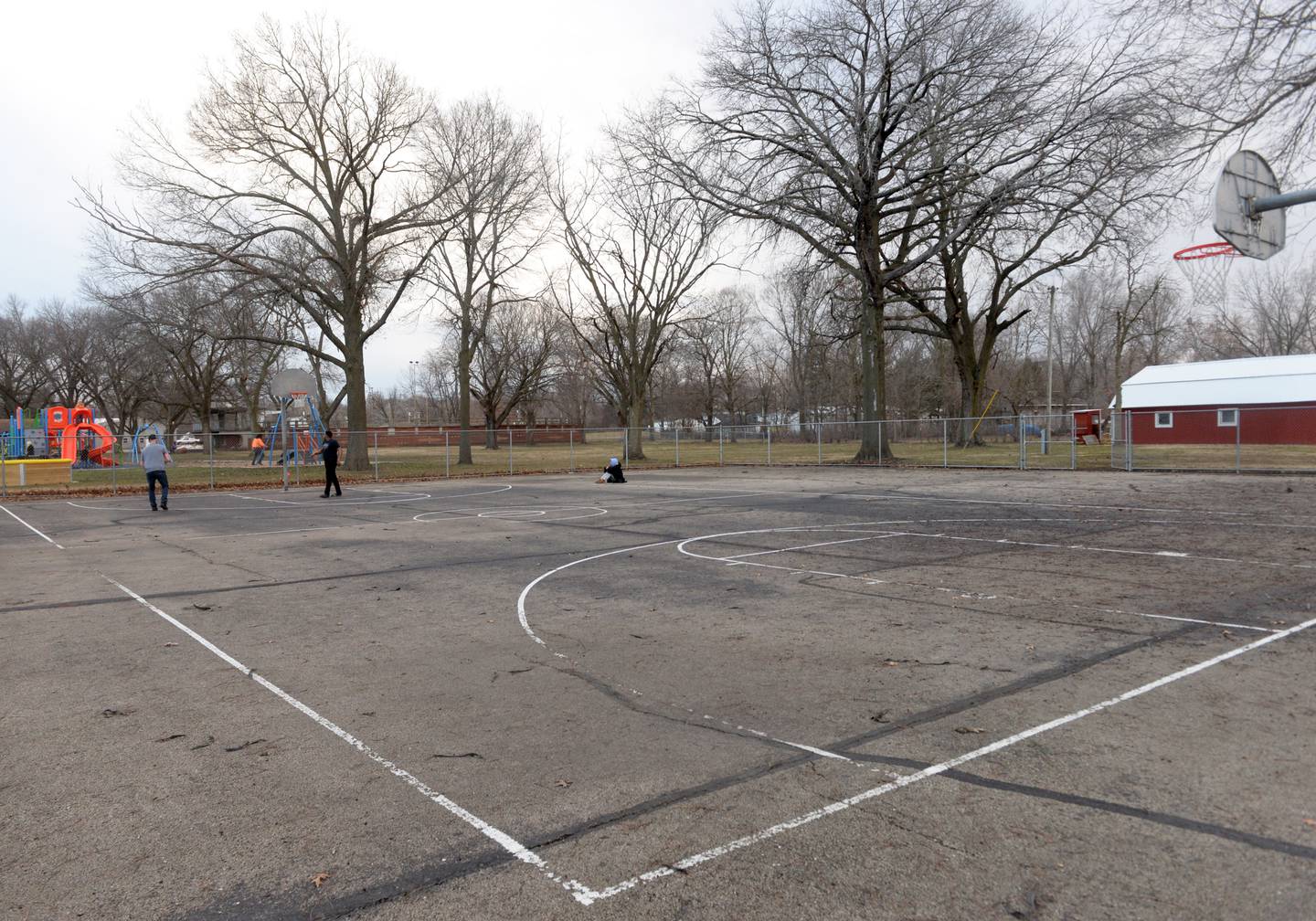 Two men shoot some hoops at the basketball court at Vaile Park in Dixon on Thursday, Feb. 8, 2024. The Dixon Park District has received a state grant to improve the court.