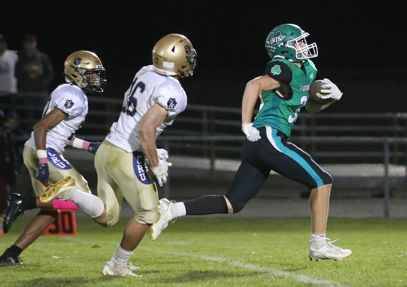 Seneca's Cameron Shriey runs ahead of Marquette's Connor Baker and teammate Payton Gutierrez to score a touchdown on Friday, Oct. 18, 2024 at Seneca High School.