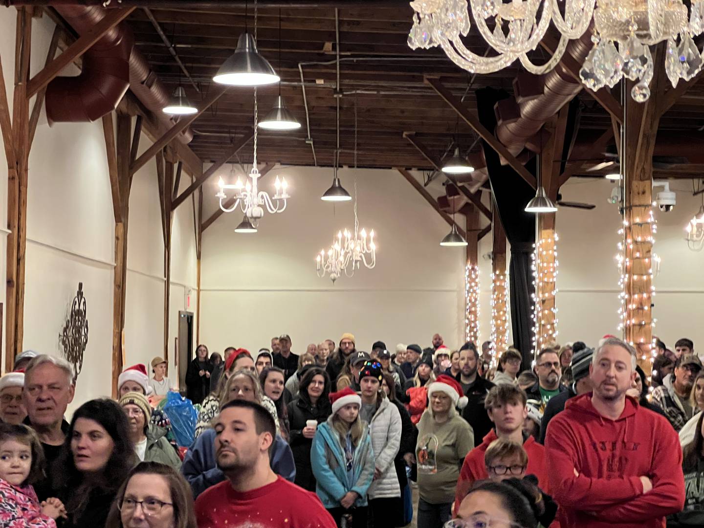 A large crowd gathered at Blumen Gardens in Sycamore before 8 a.m. on Dec. 24, 2023, to participate in annual Goodfellows gift delivery event.