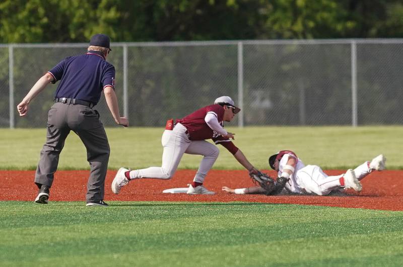 Plainfield North's Mateo Tristan (1) tags Yorkville's Jackson Roberts (13) for an out on a steal attempt during a baseball game at Yorkville High School in Yorkville on Thursday, May 16, 2024.