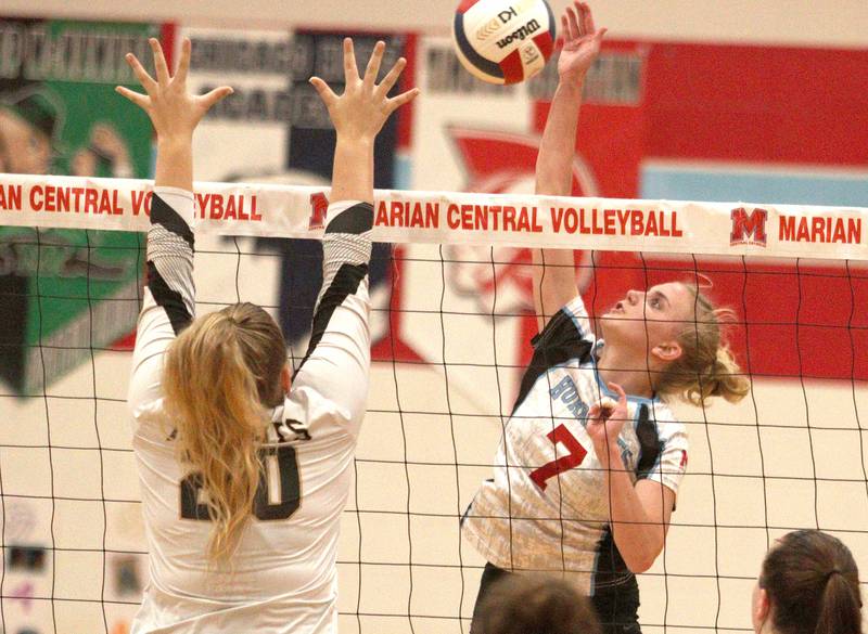 Marian Central’s Jordan Orlos sends the ball over the net against Grayslake North in girls volleyball in Woodstock Monday.