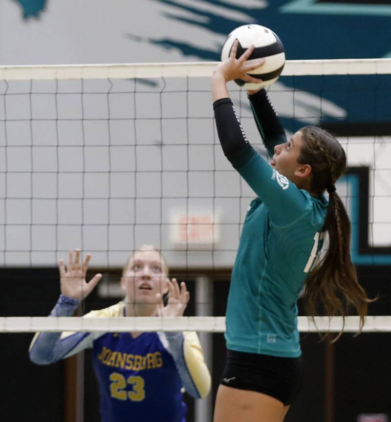 Woodstock North's Gabriella Schefke sets the ball in front of Johnsburg's Casie Majercik during a Kishwaukee River Conference volleyball match on Wednesday, Sept. 4, 2024, at Woodstock North High School.