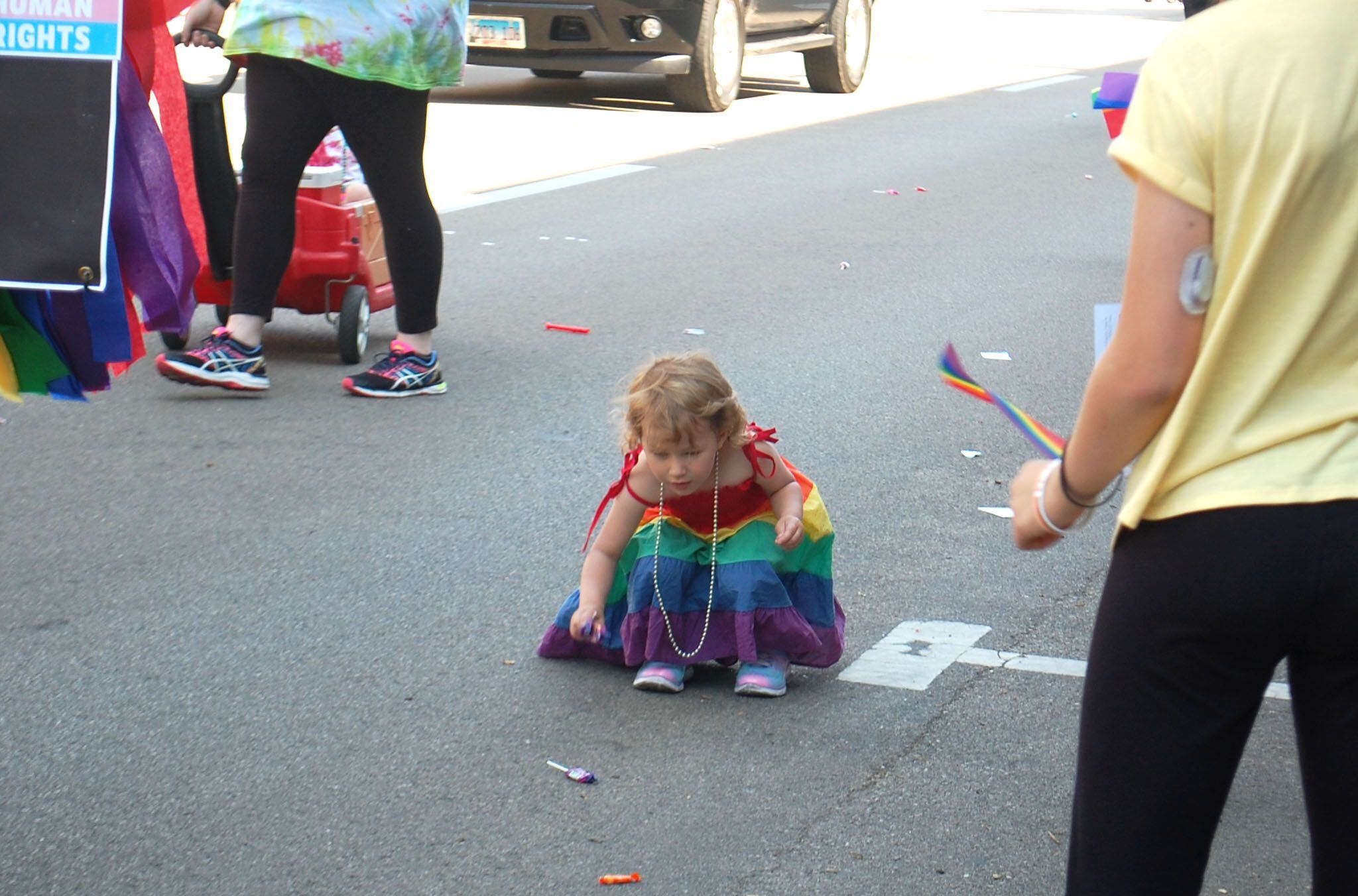 A young paradegoer collects candy during the inaugural John Fisher Dann Memorial Pride Parade at the Ottawa Family Pride Festival on Saturday, June 10, 2023, in downtown Ottawa.