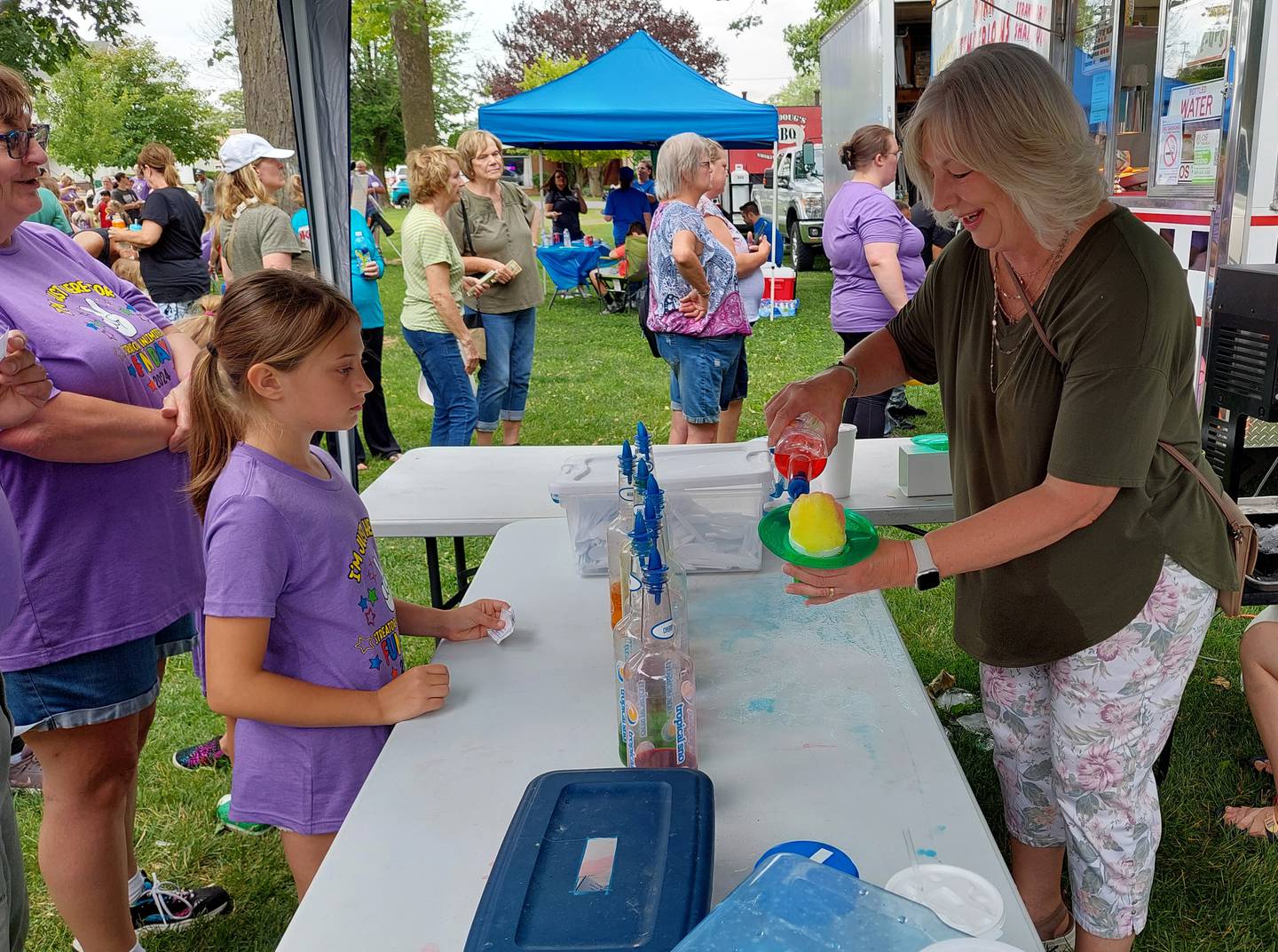 Lydia Zmia has a snow cone prepared for her Tuesday, June 4, 2024, during Streator Unlimited's Fun Day at City Park in Streator.