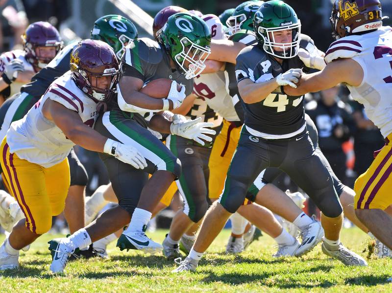 Glenbard West's JaMarcus Kelly grinds for yards behind a block by Andrew Engel during a game against Loyola on September 7, 2024 at Glenbard West High School in Glen Ellyn.