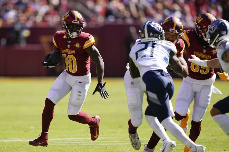 Washington Commanders wide receiver Curtis Samuel (10) rushes the ball in the first half of an NFL football game against the Tennessee Titans, Sunday, Oct. 9, 2022, in Landover, Md. (AP Photo/Alex Brandon)