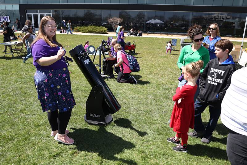 Caitlin Lee, JJC Planetarium Coordinator, talks about the eclipse as the solar eclipse is protected from a reflector telescope at the Joliet Junior College solar eclipse viewing event on Monday, April 8, 2024 in Joliet.