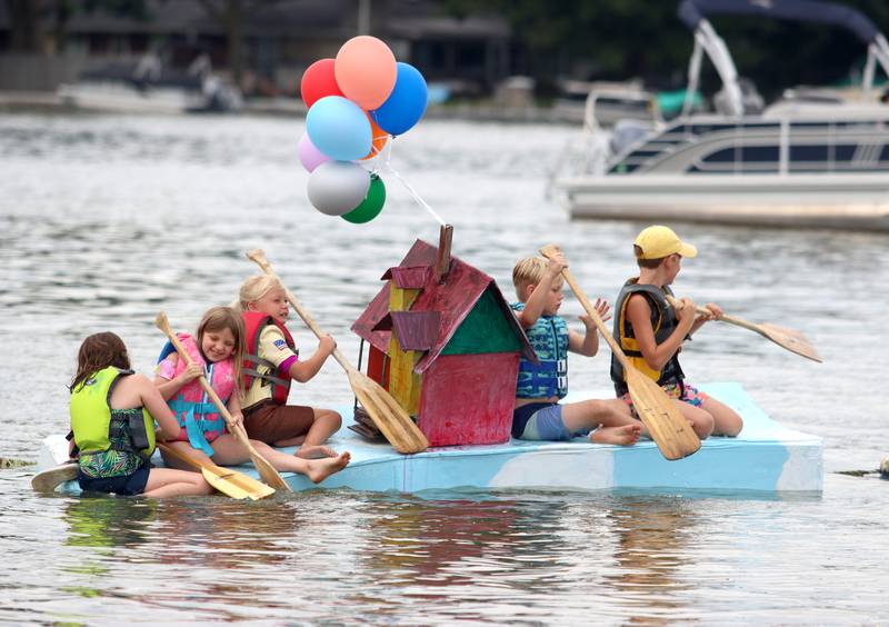 The Edgebrook Explorers group paddles through the Cardboard Regatta on Crystal Lake Saturday.