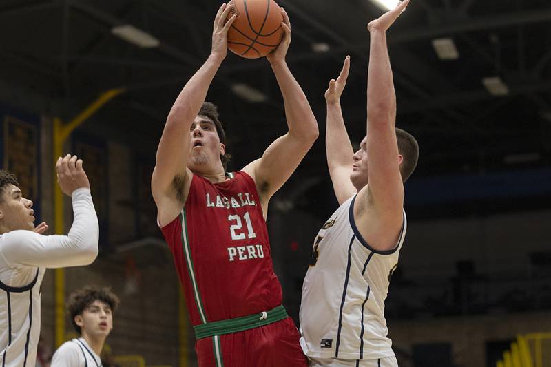 LaSalle-Peru’s Josh Senica puts up a shot in the lane against Sterling’s Lucas Austin Friday, Feb. 23, 2024 during a class 3A regional final at Sterling High School.