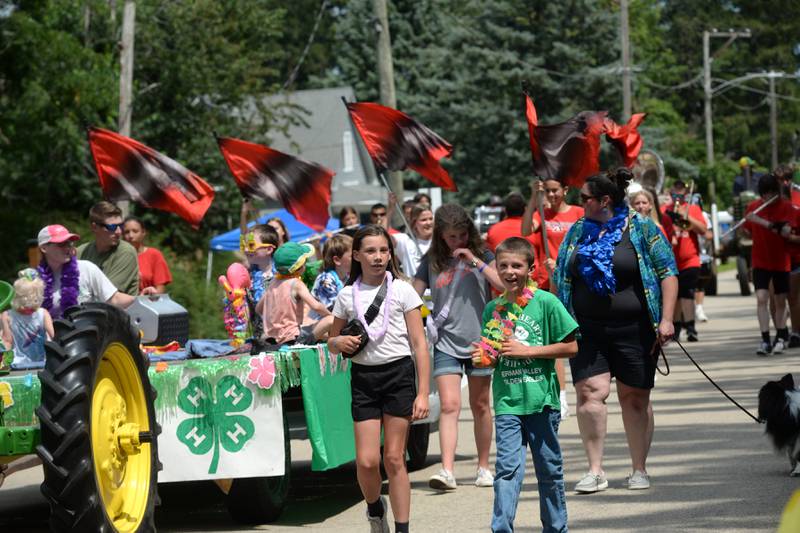 Members of the German Valley Golden Eagles 4-H Club walk with their float past Ben Miller Park in the German Valley Days parade on Saturday, July 20, 2024