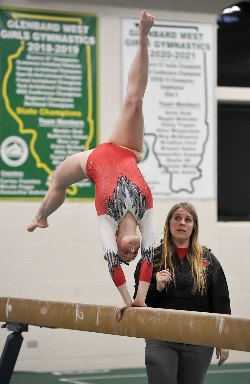 Glenbard East’s Olivia Broyles on the balance beam at the Glenbard West girls gymnastics regional meet in Glen Ellyn on Wednesday, January 31, 2024.