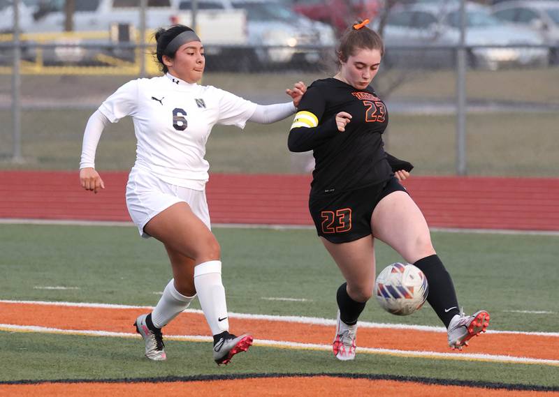 DeKalb’s Addison Elshoff kicks the ball away from Belvidere North's Keyla Suarez during their game Tuesday, March 12, 2024, at DeKalb High School.