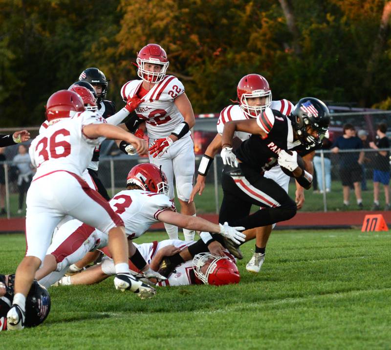 Erie-Prophetstown's Demetree Larsen (1) runs past Hall defenders during a Friday, Sept. 6, 2024 game in Prophetstown.