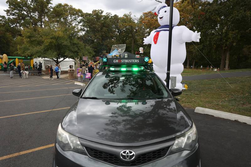 Stay Puft marshmallow man stand behind a Ghostbuster vehicle at the Hayride of Horrors on Monday, Oct. 14, 2024 at Dellwood Park in Lockport.