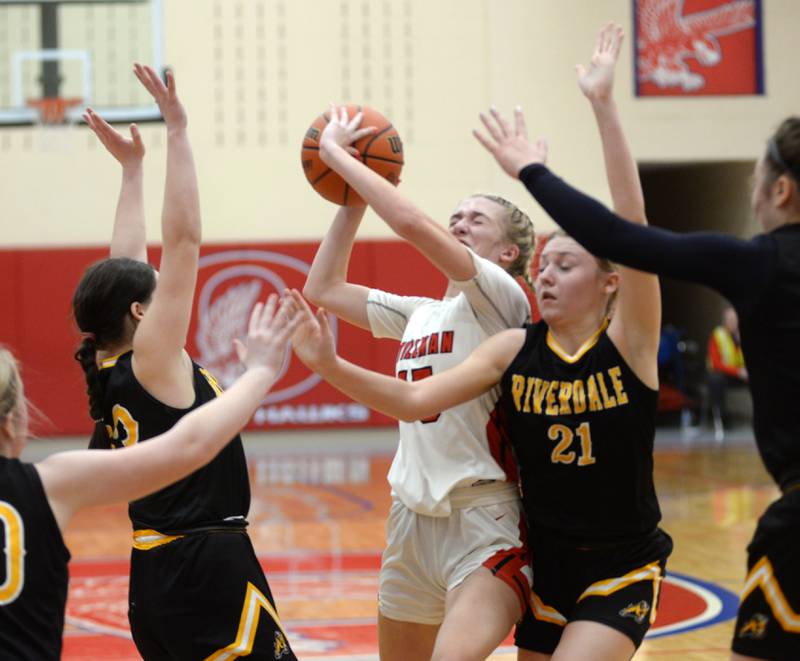 Stillman Valley's Taylor Davidson (15) drives to the basket as Riverdale's Kayleigh Hungate (21) and Jilliam Murray (23) defend on Tuesday. Feb. 20, 2024 at the 2A Oregon Sectional held at the Blackhawk Center at Oregon High School. Davidson scored 31 points in the Cardinal's 57-34 win over the Rams.