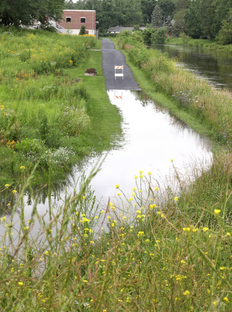 Parts of the DeKalb Nature Trail near the Kishwaukee River in Hopkins Park is blocked off after flooding Tuesday, July 16, 2024, in DeKalb after the severe thunderstorms this week have dumped heavy rains on the area. The storms caused localized damage and flooding throughout DeKalb County.