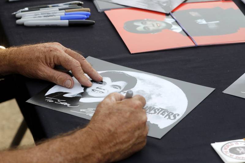 Butch Patrick, who played Eddie Munster on the 1960s show “The Munsters” signs autographs, Wednesday, Aug. 14, 2024, during an appearance at the McHenry Outdoor Theater.