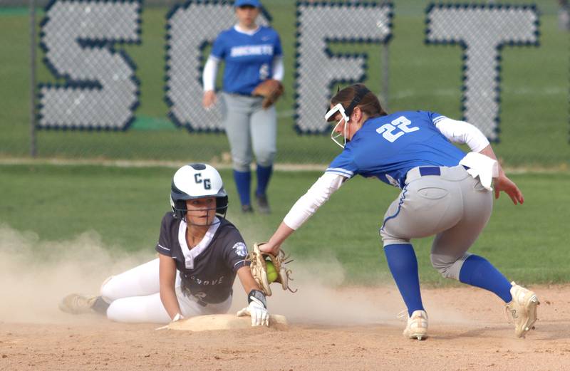 Cary-Grove’s Aubrey Lonergan, left, is safe under the tag of Burlington Central’s Anna Sanders in varsity softball at Cary Monday.