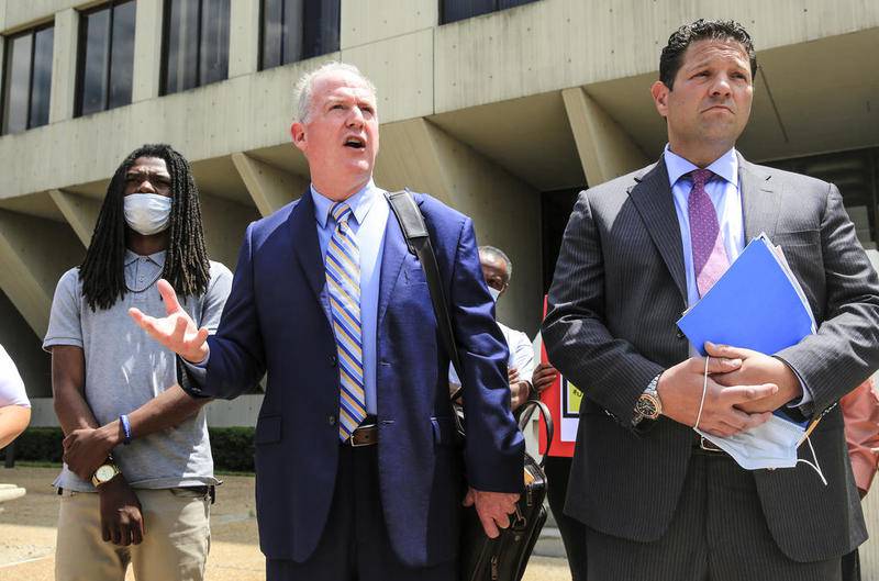 Attorneys Lawrence O'Reily (center) and Michael Baker (right) address the media Thursday after a Will County prosecutor declined to charge Victor Williams (left) and Jamal Smith in connection with a May 31 scuffle with  Joliet Mayor Bob O'Dekirk.