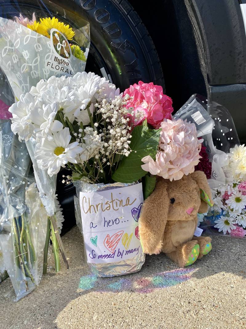 A note reads "Christina a hero...so missed by many" next to a stuffed bear near a DeKalb County Sheriff's Office vehicle displayed on the DeKalb County Courthouse lawn in Sycamore on Saturday, March 30, 2024. Mourners have visited the site to leave trinkets, flowers and other tokens in memory of sheriff's deputy Christina Musil, who was killed while on duty after her squad car was rear-ended by a truck Thursday, March 28, 2024.