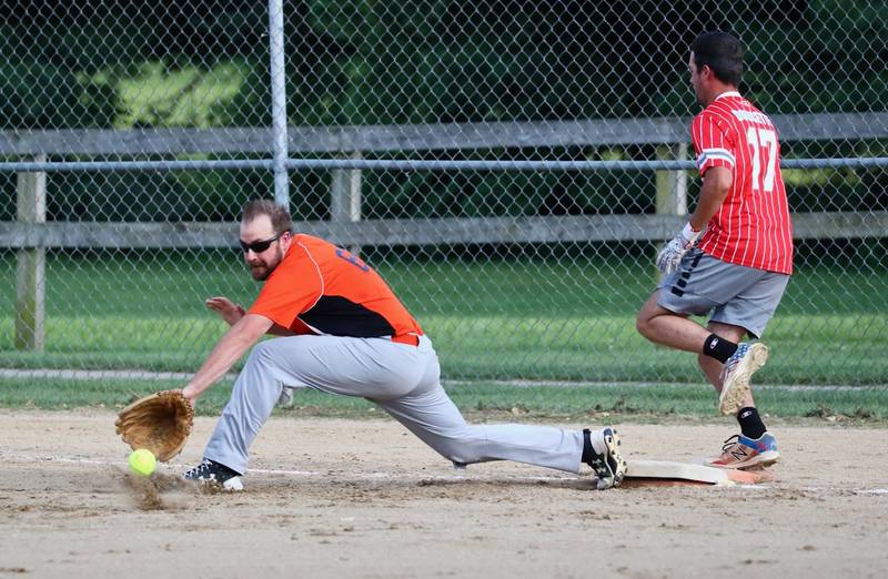 People Church first baseman Andy Austin makes a stretch for the ball in Friday's Princeton Park District Fastpich League tournament play at Westside Park.