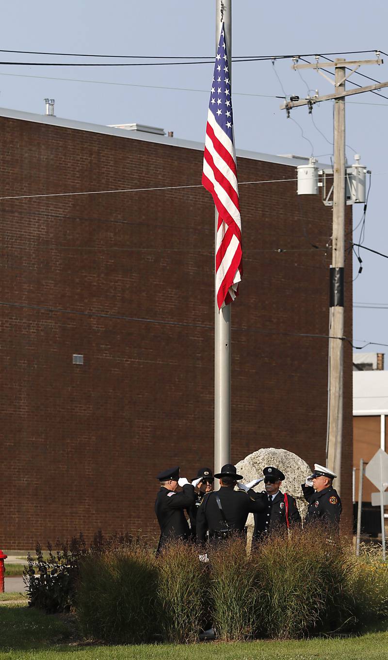 The flag is raised to half mast during a 9/11 remembrance ceremony on Sept. 11, 2024, at Veteran's Memorial Park in McHenry.