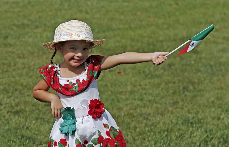 Elena Herenandez, 3, of Woodstock waves a Mexican flag during the annual Hispanic Connections Mexican Independence Day Celebration on Sunday, Sept. 15, 2024, in the Historic Woodstock Square. The celebration featured music, food and culture.