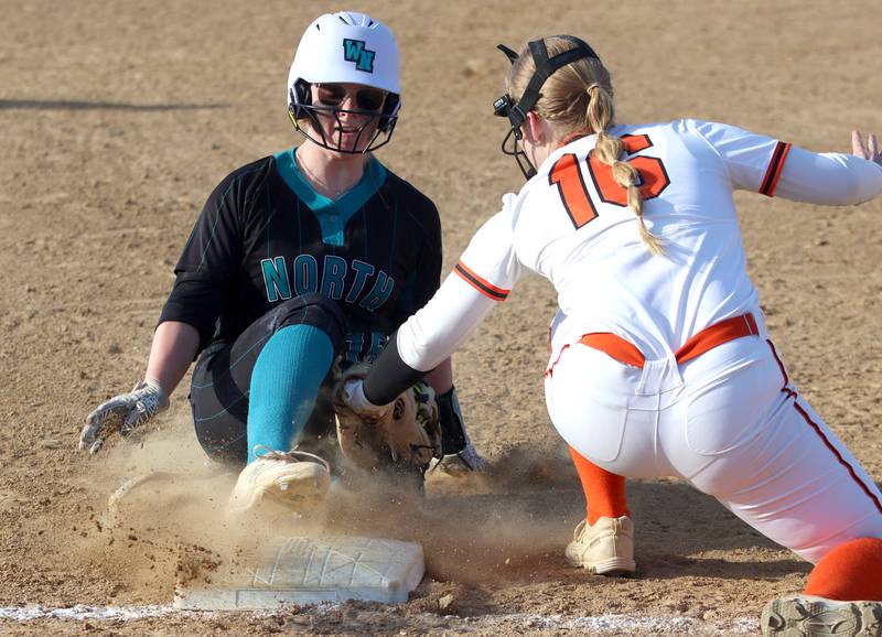 Crystal Lake Central’s Cassidy Murphy, right, tags out Woodstock North’s Mackenzie Schnulle at third base in varsity softball at Crystal Lake Friday.