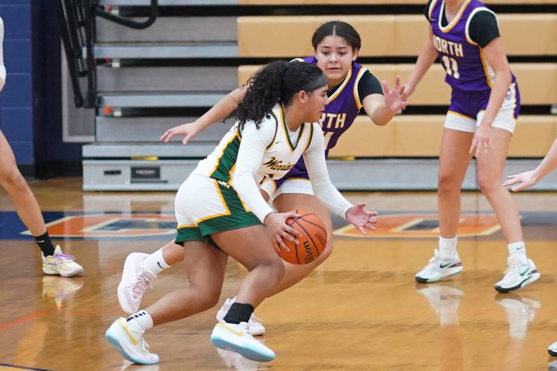 Waubonsie Valley's Arianna Garcia (1) drives to the hoop against Downers Grove North's Kaitlyn Parker (24) during a Oswego semifinal sectional 4A basketball game at Oswego High School on Tuesday, Feb 20, 2024.