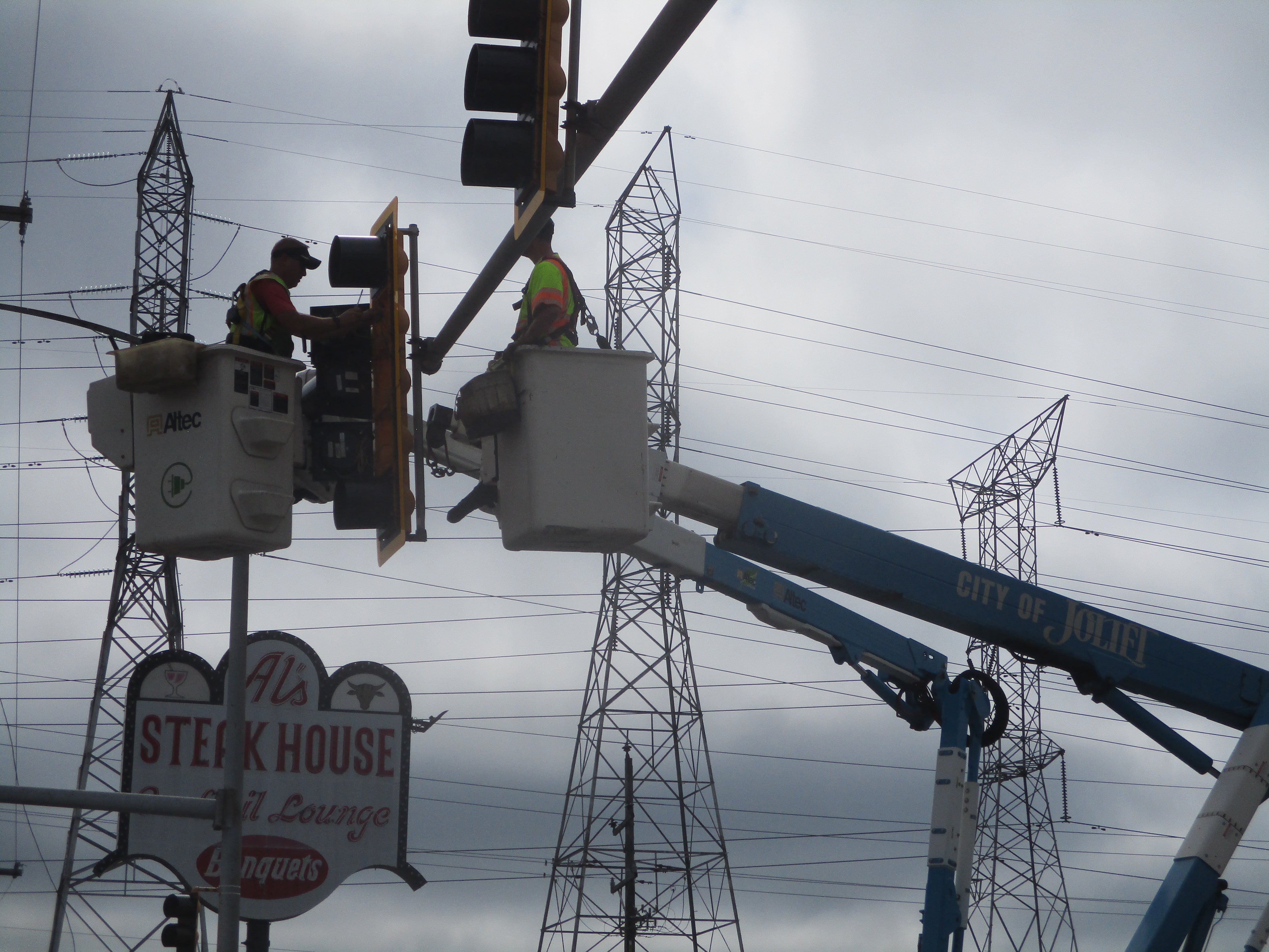 A crew repairs the traffic lights at Jefferson Street and Hammes Avenue, one of many intersection in Joliet where the traffic lights were out Tuesday morning because of storm damage the night before. July 16, 2024