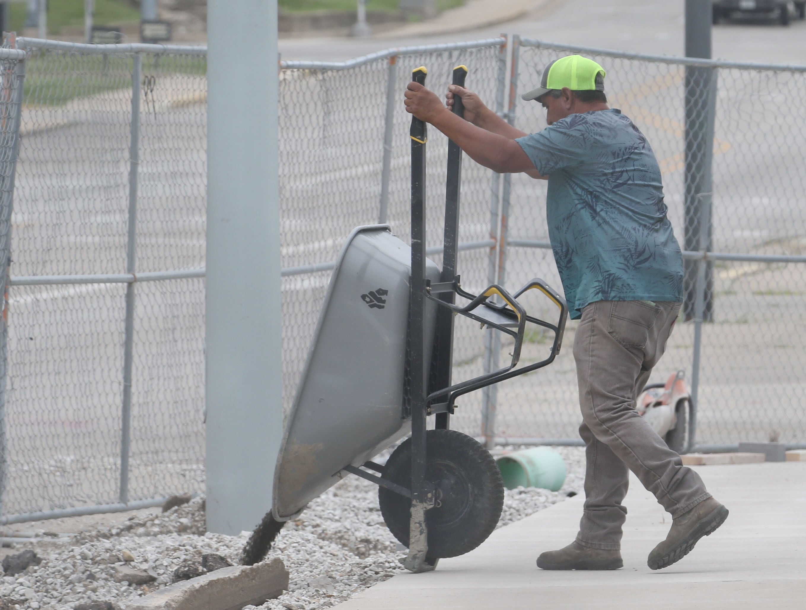 A worker dumps a load of rock behind the former Maytag Building on Tuesday, Aug. 6, 2024 downtown La Salle.