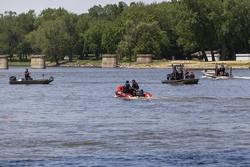 Firefighters in four boats measure and mark spots along the Rock River near downtown Dixon Thursday, May 23, 2024 for the placement of marker buoys. This part of the river has never been marked with the floats.