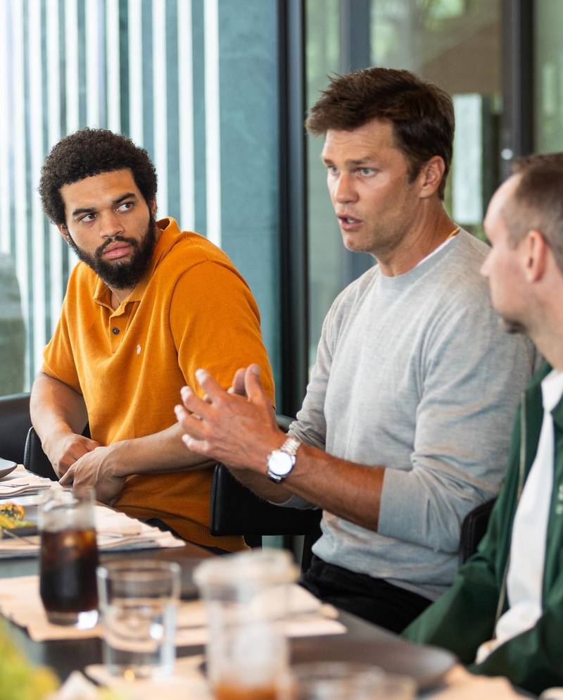 Caleb Williams listens to legendary NFL quarterback Tom Brady over breakfast on Sunday at an event hosted by Fanatics in Los Angeles.