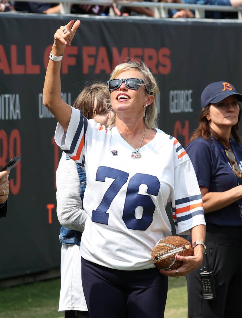 Misty McMichael, wife of 1985 Super Bowl champion Chicago Bear Steve McMichael acknowledges the crowd during the Bears Tennessee Titans game Sunday, Sept. 8, 2024, at Soldier Field in Chicago. Many teammates of McMichael were on hand for a halftime celebration honoring new Hall of Famer McMichael.