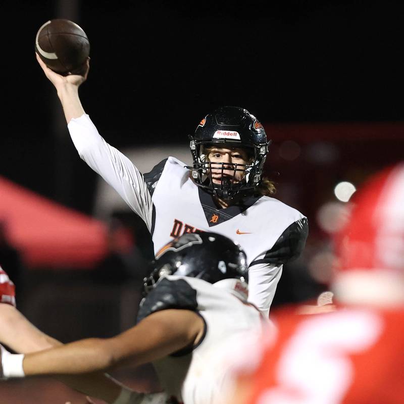 DeKalb's Cole Latimer looks for an open receiver in the Naperville Central secondary during their game Friday, Oct. 6, 2023, at Naperville Central High School.