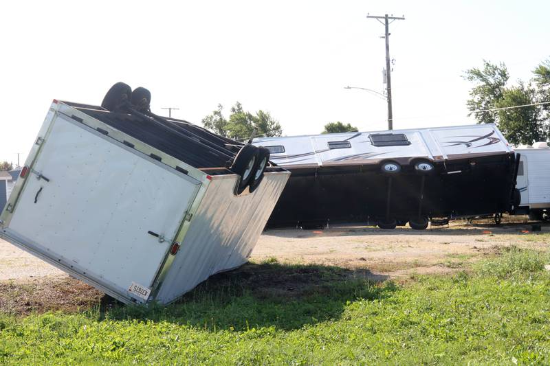 A trailer and a camper lie overturned Monday, July 15, 2024, at Cortland Coach and Camper Storage at the northeast corner of Route 38 and Somonauk Road in Cortland. High Winds and heavy storms hit DeKalb County overnight causing downed trees and power outages in the area.