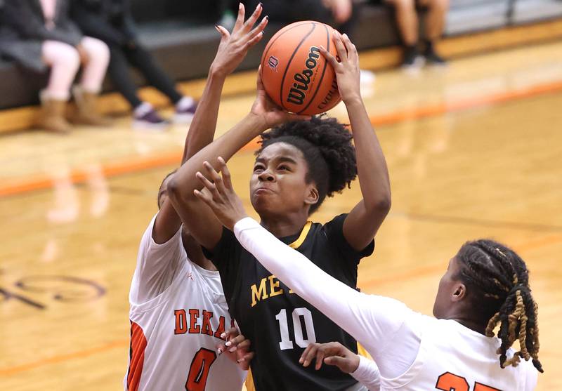 Metea Valley's Arainna Hammons goes to the basket between two DeKalb defenders during their game Friday, Jan. 19, 2024, at DeKalb High School.