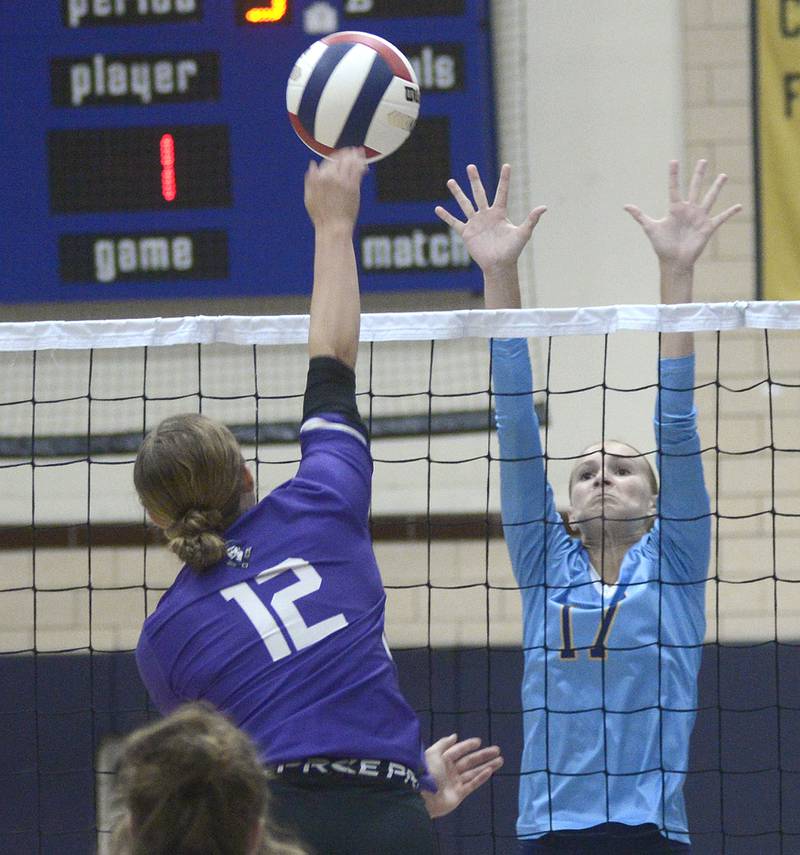 Marquette’s Avery Durdan sets to block this shot by Lexington’s Eva McCue  in the first match Tuesday at Marquette.