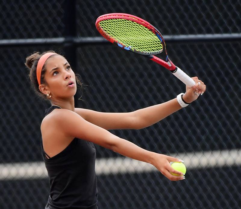 St. Charles East’s Kelsey Jacob serves against St. Charles North’s Alli Gizewicz at the DuKane Conference girls tennis tournament at Wheaton Warrenville South High School on Thursday, October 5, 2023.