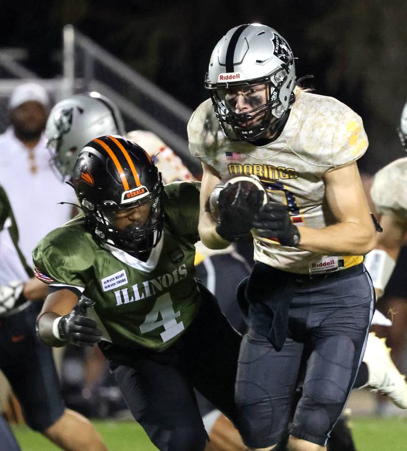 Kaneland's Carter Grabowski tries to avoid the tackle of DeKalb's Damarrion Belue during their game Friday, Sept. 13, 2024, at Kaneland High School in Maple Park.