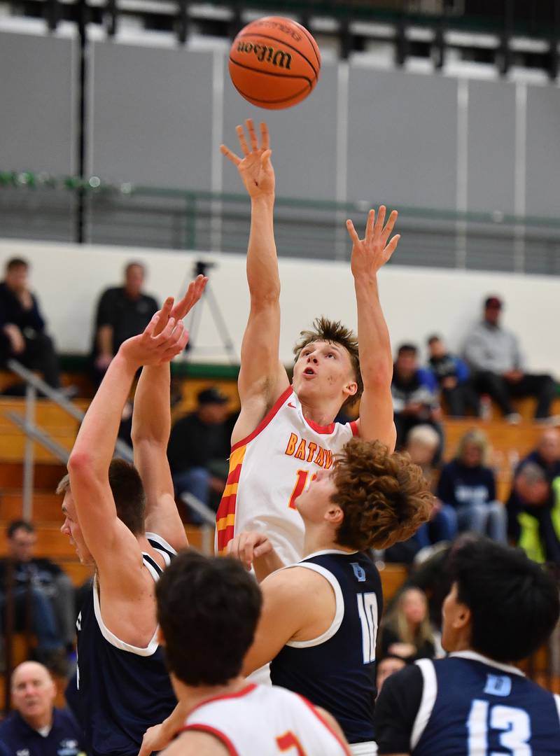 Batavia's Nate Nazos (top) shots over a crowd during a Jack Tosh Classic game against Downers Grove South on Dec. 26, 2023 at York High School in Elmhurst.