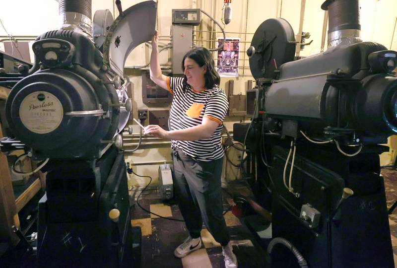 Egyptian Theatre Marketing and Communications Director Jeanine Holcomb talks Tuesday, Oct. 3, 2023, in the projector room about ghost sightings that have been report in the balcony of the theater in DeKalb. The balcony is just one of the places in the Egyptian where there have been reports of paranormal activity.