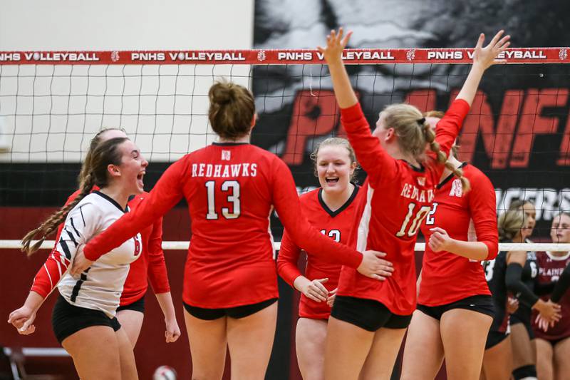 Naperville Central celebrates a point during volleyball match between Naperville Central at Plainfield North.  Aug 28, 2024.