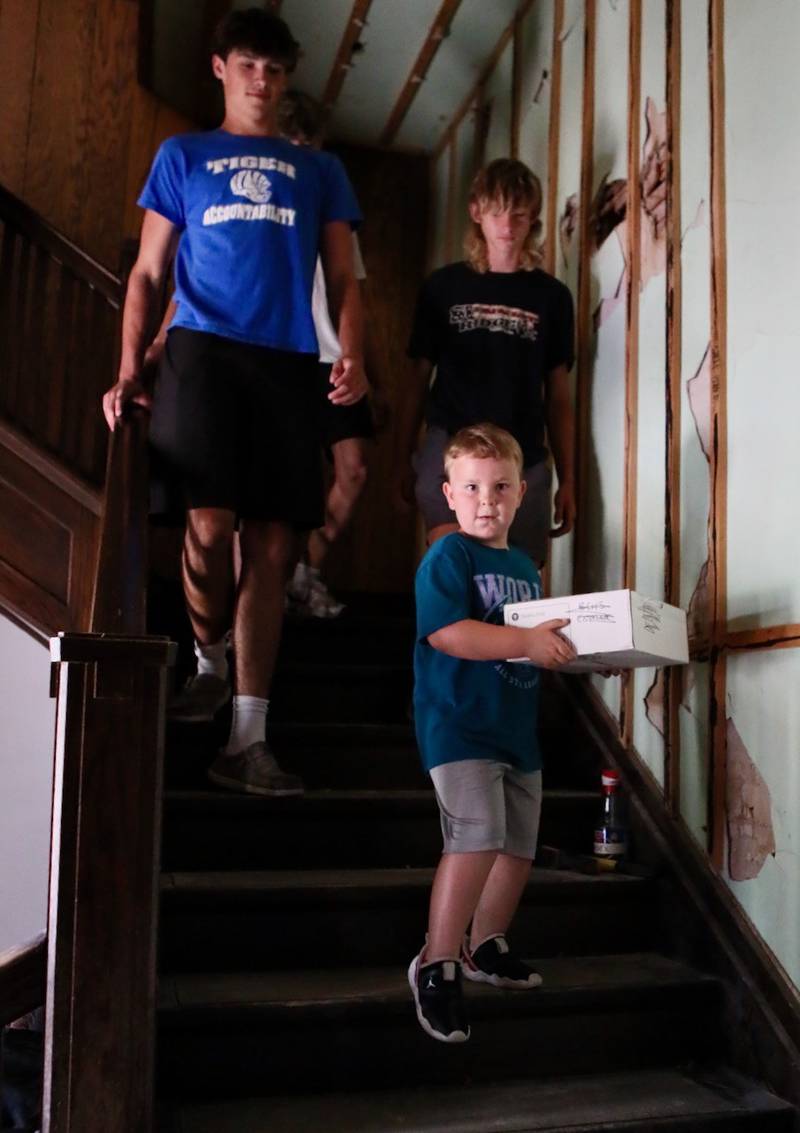 Roman Pearson, 4, son of Tiger football coach Ryan Pearson, helped the Tiger football team move boxes the third floor of the Sash Stalter Matson Building to the basement in a matter of 15 minutes for the Bureau County Historical Society.
