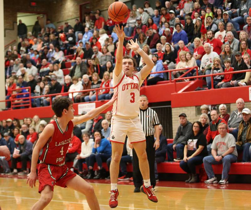 Ottawa's Levi Sheehan shoots a jump shot over L-P's Jack Jereb in Kingman Gymnasium on Friday, Feb. 10, 2023 at Ottawa High School.