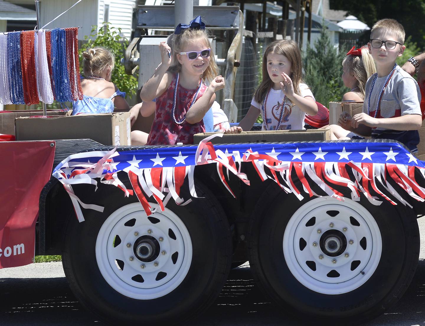 Children on a patriotic float dance and wave to those along the parade route Sunday, July 10, 2022, during the Marseilles Fun Days parade.